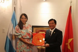 Phó Bí thư Thường trực Tỉnh ủy Bình Dương Nguyễn Hoàng Thao tặng quà lưu niệm cho bà Julieta De San Felix, Cố vấn cấp cao về Hợp tác quốc tế và Hội nhập khu vực của Thống đốc tỉnh Santa Fe của Argentina. (Ảnh: Ngọc Tùng/TTXVN)