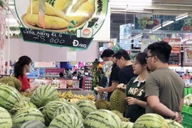 Người tiêu dùng Thành phố Hồ Chí Minh chọn mua trái cây tại siêu thị. (Ảnh: Mỹ Phương/TTXVN)