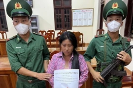 Đối tượng Giàng Thị Sì cùng tang vật vụ án. (Ảnh: TTXVN phát)