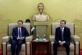 Phó Trưởng ban Thường trực Ban Tuyên giáo Trung ương Lại Xuân Môn tiếp Phó Trưởng ban Tuyên truyền Trung ương Đảng Cộng sản Trung Quốc, Chủ nhiệm Văn phòng Thông tin Quốc vụ viện Trung Quốc Tôn Nghiệp Lễ. (Ảnh: TTXVN phát)