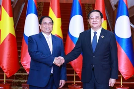 Thủ tướng Phạm Minh Chính hội kiến Thủ tướng Lào Sonexay Siphandone, Chủ tịch ASEAN 2024. (Ảnh Dương Giang/TTXVN)