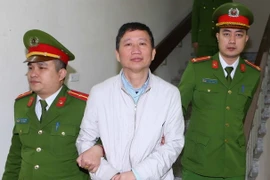 Cảnh sát dẫn giải bị cáo Trịnh Xuân Thanh về trại giam. (Ảnh: An Đăng/TTXVN)