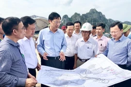 Bí thư Tỉnh ủy Quảng Ninh Nguyễn Văn Đọc (thứ hai, bên trái) kiểm tra đất đai trên địa bàn huyện Vân Đồn. (Ảnh: Nguyễn Hoàng/TTXVN)