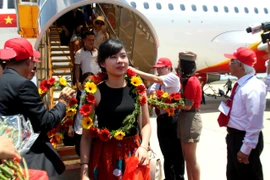 Những hành khách đầu tiên xuống sân bay Tuy Hòa trong buổi khai trương tuyến bay. (Ảnh: Thế Lập/TTXVN)