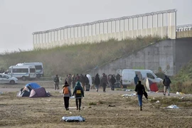  Người di cư sơ tán khỏi khu trại ở Calais ngày 26/10. (Nguồn: AFP/TTXVN)