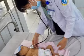 Bác sỹ thăm khám cho bệnh nhi sau phẫu thuật. (Ảnh: Thanh Sang/TTXVN)