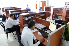 Cán bộ, nhân viên các Sở, ngành làm việc trong Tòa nhà Trung tâm Hành chính thành phố Đà Nẵng. (Ảnh: Trần Lê Lâm/TTXVN)