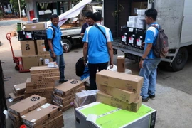 Các nhân viên phục vụ đang vận chuyển các linh kiện và thiết bị điện tử phục vụ cho ASIAD 2018. (Ảnh: Trọng Tuệ/TTXVN