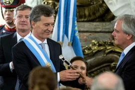 Tổng thống đắc cử Argentina Mauricio Macri (trái) nhận cây baton tượng trưng cho quyền lực tại lễ tuyên thệ nhậm chức ở thủ đô Buenos Aires ngày 10/12. (Nguồn: THX/TTXVN)