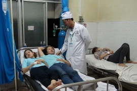 Bác sỹ đang theo dõi tình trạng của các công nhân nhập viện cấp cứu. (Ảnh: Đậu Tất Thành/TTXVN)