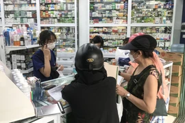 Số ca mắc COVID-19 tăng nhanh khiến các hiệu thuốc tại Hà Nội luôn 'tấp nập' người dân đến mua các loại sản phẩm để phòng dịch. (Ảnh: Việt Anh/Vietnam+)