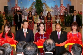 Thủ tướng Chính phủ Nguyễn Xuân Phúc và các đại biểu cắt băng khai trương gian hàng. (Ảnh: Thống Nhất/TTXVN)