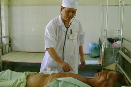 Bác sỹ kiểm tra sức khỏe bệnh nhân. (Ảnh: Chanh Đa/TTXVN)