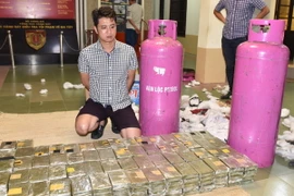 Đối tượng Nguyễn Quốc Hùng cùng tang vật tại cơ quan Công an. (Ảnh: TTXVN phát)