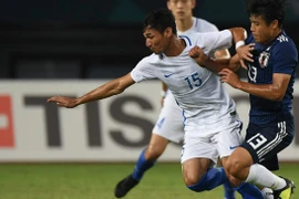 Malaysia (áo trắng) thua Nhật Bản ở phút 89. (Nguồn: AFC)