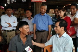 Ông Đào Văn Hiếu, Tổng Lãnh sự quán Việt Nam tại 4 tỉnh Nam Lào thăm, động viên các gia đình bị ảnh hưởng sau sự cố vỡ đập thủy điện Xe pian-Xe NamNoy. (Ảnh: Quang Thái/TTXVN)