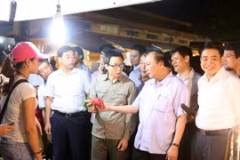 Thủ tướng Nguyễn Xuân Phúc đi kiểm tra vệ sinh an toàn thực phẩm tại chợ đầu mối Long Biên. (Ảnh: Thống Nhất/TTXVN)
