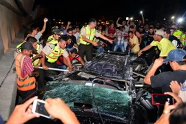 Nhân viên cứu hộ và các tình nguyện viên giải cứu nạn nhân bị mắc kẹt trong ôtô sau trận động đất ở Guayaquil, Ecuador. (Nguồn: AFP/TTXVN)