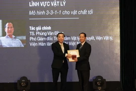 Bộ trưởng Bộ Khoa học và Công nghệ Chu Ngọc Anh (bên trái) trao giải thưởng "Nhà khoa học trẻ có công trình khoa học xuất sắc" cho tiến sỹ Phùng Văn Đồng, Viện Vật Lý, Viện Hàn lâm Khoa học và Công nghệ Việt Nam. (Ảnh: Anh Tuấn/TTXVN)
