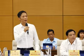 Bộ trưởng Bộ Công Thương Trần Tuấn Anh trả lời các câu hỏi của đại biểu. (Ảnh: Văn Điệp/TTXVN)