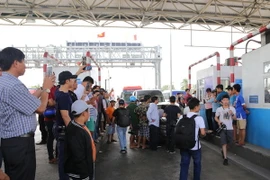 BOT Cai Lậy hỗn loạn do tài xế dùng mọi cách để dừng tại làn thu phí. (Ảnh: Nam Thái/TTXVN)