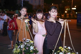 Trong chương trình này, các bạn trẻ sẽ được thử sức mình khi hóa thân vào các cô gái điệu đàng với gánh hàng hoa trên phố. (Ảnh: PV/Vietnam+)