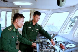 Thiếu tá Khúc Ngọc Minh cùng đồng đội kiểm tra kỹ thuật phương tiện chuẩn bị tuần tra kiểm soát trên biển. (Ảnh: Minh Thu/TTXVN)