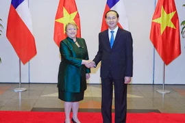 Chủ tịch nước Trần Đại Quang đón Tổng thống Michelle Bachelet Jeria. (Ảnh: Nhan Sáng/TTXVN)