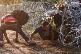 Hàng rào dây thép gai không ngăn nổi người nhập cư cố gắng xâm nhập vào Hungary năm 2015. (Nguồn: dw.com)