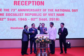 Đại sứ Việt Nam tại Lào Nguyễn Bá Hùng (giữa) cùng các lãnh đạo Lào mừng Quốc khánh Việt Nam. (Ảnh: Phạm Kiên/TTXVN)