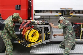 Các chiến sỹ kiểm tra trang thiết bị xe cứu nạn, cứu hộ. (Ảnh: Hoàng Hải/TTXVN)