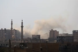 Khói bốc lên sau một cuộc giao tranh ở quận al-Sinaa, phía Đông thành phố Raqa. (Nguồn: AFP/TTXVN)