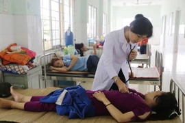 Khám cho bệnh nhân nhập viện nghi ngộ độc thực phẩm. (Ảnh: Nam Thái/TTXVN)