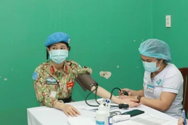 Các chiến sỹ Bệnh viện dã chiến cấp 2 số 3 được khám sàng lọc trước khi tiêm vaccine phòng COVID-19. (Ảnh: Đinh Hằng/TTXVN)