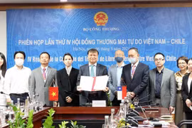 Thứ trưởng Bộ Công Thương Đỗ Thắng Hải ký kết Biên bản phiên họp tại đầu cầu Hà Nội. (Ảnh: Trần Việt/TTXVN)