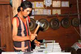 Ông A Thui biểu diễn chiếc đàn T’rưng sắt do chính ông chế tác. (Ảnh: Khoa Chương/TTXVN)