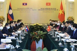 Bộ Ngoại giao Lào Saleumsay Kommasith và Thứ trưởng Ngoại giao Nguyễn Minh Vũ. (Ảnh: TTXVN)