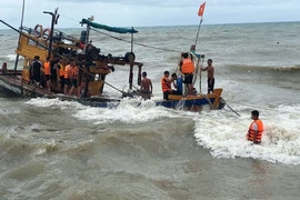 Cán bộ, chiến sỹ Biên phòng Lại Sơn cứu hộ tàu gặp nạn. (Ảnh: TTXVN phát)