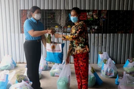 Liên đoàn Lao động tỉnh Kiên Giang trao lương thực, thực phẩm cho đoàn viên, người lao động Khu Cảng cá Tắc Cậu, xã Bình An, huyện Châu Thành (Kiên Giang). (Ảnh: Lê Huy Hải/TTXVN) 