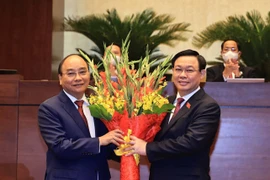 Chủ tịch Quốc hội Vương Đình Huệ chúc mừng Chủ tịch nước Nguyễn Xuân Phúc. (Ảnh: Thống Nhất/TTXVN) 