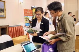 Doanh nghiệp Hội An giới thiệu với khách hàng các gói sản phẩm, dịch vụ tour. (Ảnh: Mỹ Phương/TTXVN)