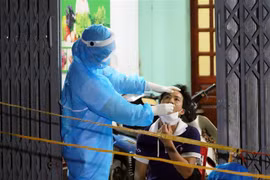 Lực lượng y tế lấy mẫu xét nghiệm toàn bộ nhân khẩu thôn Phú Đa, xã Công Lý, huyện Lý Nhân, tỉnh Hà Nam. (Ảnh: Đại Nghĩa/TTXVN)