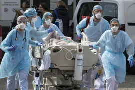 Nhân viên y tế chuyển bệnh nhân COVID-19 tại bệnh viện ở Mulhouse, miền Đông Pháp. (Ảnh: AFP/TTXVN)