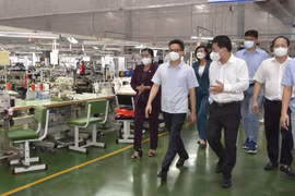 Phó Thủ tướng Vũ Đức Đam kiểm tra mô hình '3 tại chỗ' tại Công ty TNHH New Apparel Far Eastern Việt Nam (Khu công nghiệp Bắc Đồng Phú, thị trấn Tân Phú, huyện Đồng Phú). (Ảnh: Diệp Trương/TTXVN)