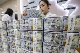 Kiểm tiền USD tại ngân hàng Hana ở thủ đô Seoul, Hàn Quốc ngày 4/7. (Ảnh: EPA-EFE/TTXVN)