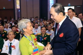Chủ tịch nước Trần Đại Quang thăm hỏi các Mẹ Việt Nam Anh hùng dự hội nghị. (Ảnh: Nhan Sáng/TTXVN)