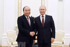 Tổng thống Nga Vladimir Putin đón Chủ tịch nước Nguyễn Xuân Phúc. (Ảnh: TTXVN)