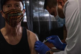 Nhân viên y tế tiêm vaccine phòng cúm mùa cho người dân tại Detroit, bang Michigan, Mỹ. (Ảnh: AFP/TTXVN)