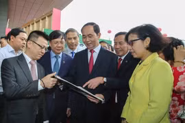 Chủ tịch nước Trần Đại Quang thăm gian trưng bày của TTXVN tại Hội báo toàn quốc. (Ảnh: Lê Minh Sơn/Vietnam+