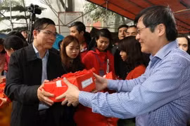 Phó Bí thư Thường trực tỉnh ủy Hải Dương Vũ Văn Sơn phát ngũ cốc cho các đại biểu và nhân dân. (Ảnh: Mạnh Minh/TTXVN)